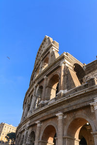 Low angle view of historical building against blue sky