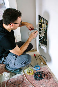 Side view of electrician working at home