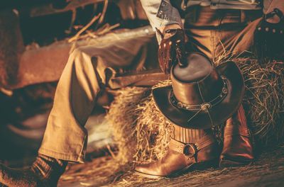 Low section of cowboy holding hat