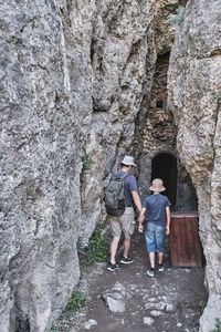 Rear view of people on rock