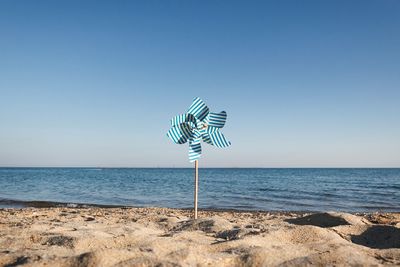 Scenic view of beach against clear blue sky