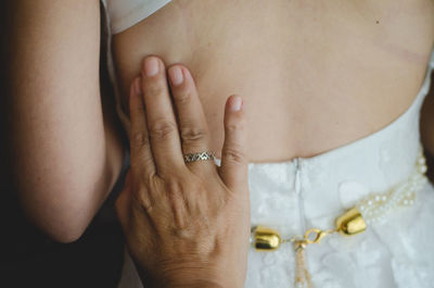 Cropped hand touching bride