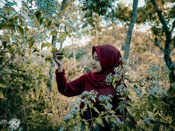 Portrait of a young woman on tree