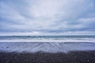 Scenic view of sea against cloudy sky