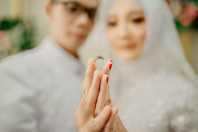 Midsection of couple holding hands