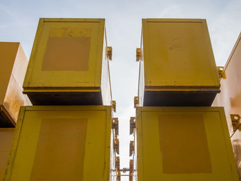 Low angle view of yellow construction containers