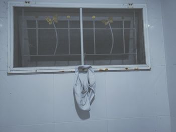 Close-up of glass window against building