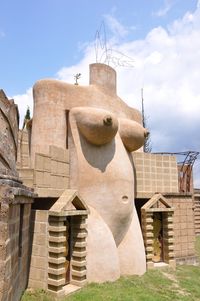 Low angle view of statues on building against sky