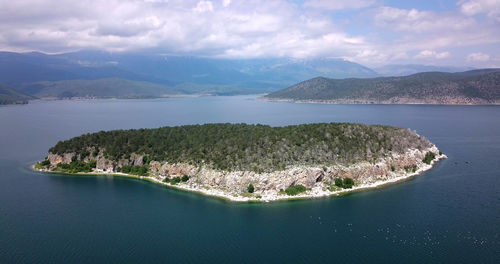 Panoramic view of sea and mountains against sky