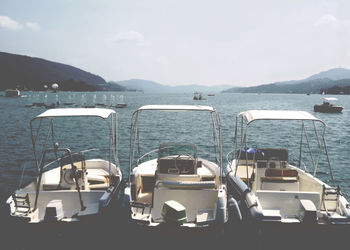 Boats in lake against sky