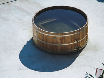 High angle view of water in wooden container during sunny day