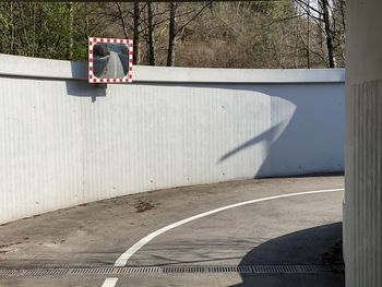 Shadow of man on street against wall