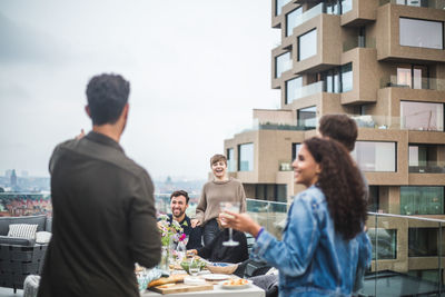 Young friends enjoying during social gathering on rooftop