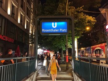 Information sign on illuminated city at night