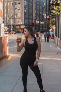 Full length of woman on street in city