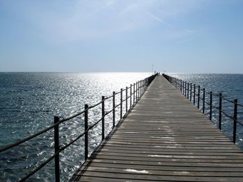 Pier over sea against sky