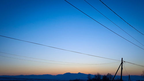 Low angle view of birds against clear sky