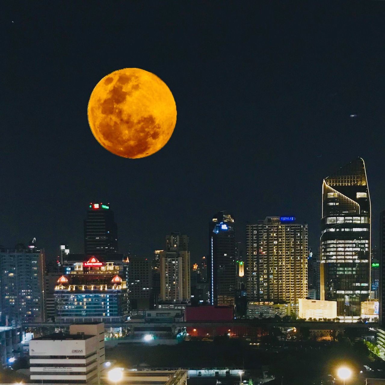 ILLUMINATED CITYSCAPE AGAINST SKY AT NIGHT