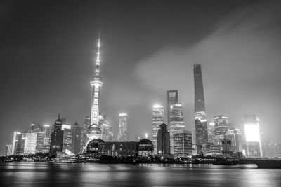 Low angle view of illuminated skyscrapers against sky at night