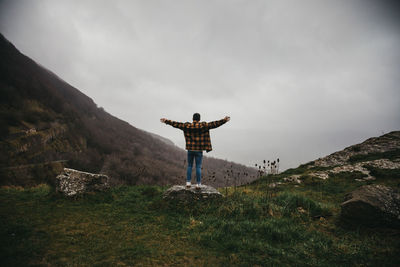 Man standing on field against sky