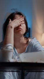 Portrait of beautiful young woman sitting at home