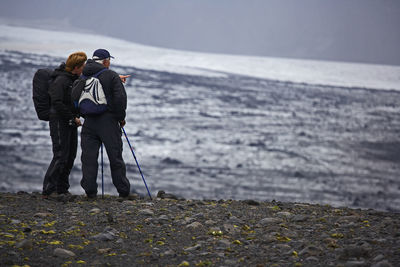 Woman pointing towards glacier on laugavegur trek