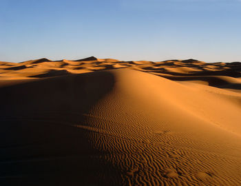 Sand dune against sky