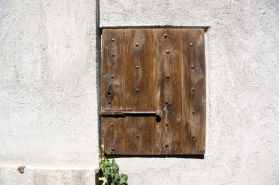 Close-up of closed door on wall