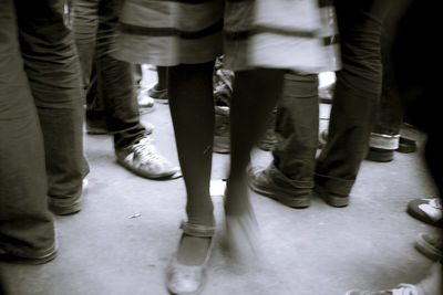 Low section of man standing on tiled floor