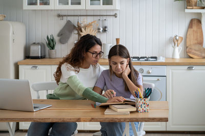 Young woman using laptop while sitting at home