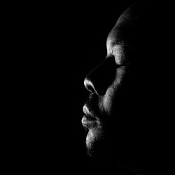 Digital composite image of man in darkness