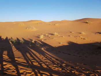 Scenic view of desert against clear sky