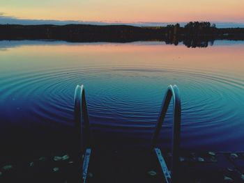 Scenic view of calm lake at sunset