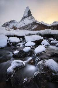 Scenic view of frozen lake against sky during winter