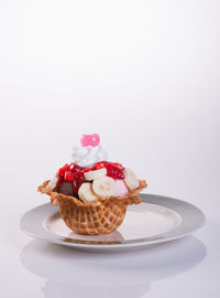 Chocolate cake on plate against white background