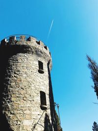 Low angle view of old building against blue sky