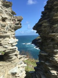 Scenic view of rocks on beach against sky