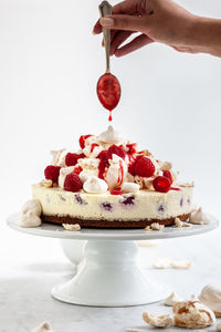 Cropped hand of woman holding cake