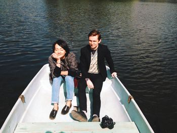 Couple sitting in boat on lake