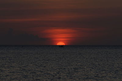 Scenic view of sea against orange sky