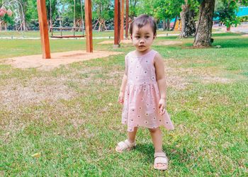 Cute little asian thai girl standing in the park.