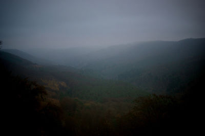 Scenic view of mountains against cloudy sky