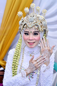 Close up of a young woman getting married looking at the camera