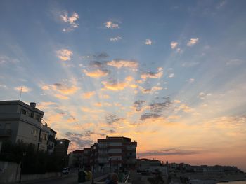 Low angle view of building against sky at sunset