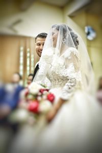 Close-up of couple holding bouquet