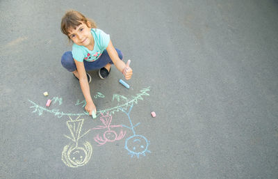 Girl drawing on road