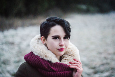 Portrait of young woman standing outdoors during winter