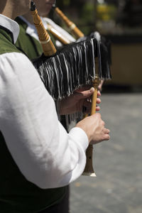 Midsection of man holding umbrella