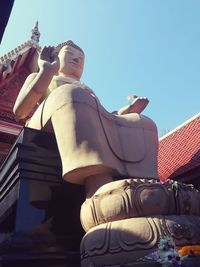 Low angle view of sculpture against blue sky