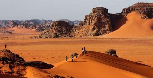 People at desert on sunny day